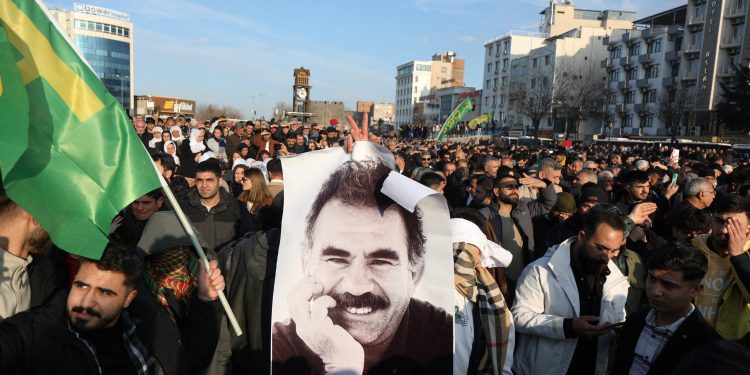 A demonstrator holds a picture of jailed Kurdish militant leader Abdullah Ocalan during a rally in Diyarbakir, Turkey, February 27, 2025. REUTERS/Sertac Kayar