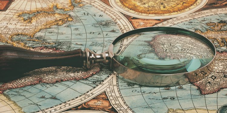 Magnifying glass and ancient old map