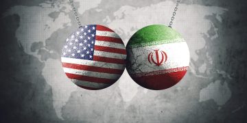 World War 3 illustration concept with USA & Iran flags on two wrecking balls colliding each other